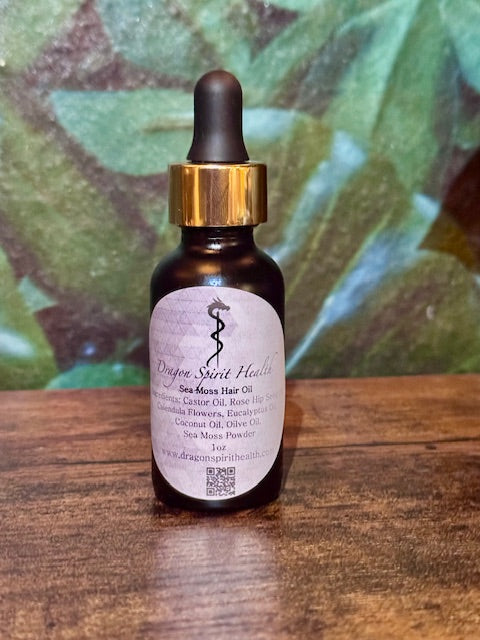 Bottle of Sea Moss Hair Oil on a wooden table