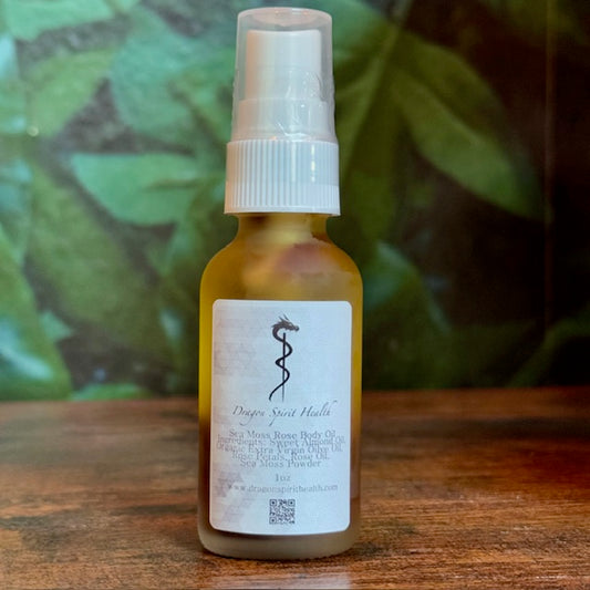 Bootle of Sea Moss Rose Body Oil on a wooden table