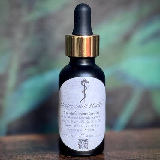 A bottle of Sea Moss Womb Care Oil with a dropper cap. The label includes the product name and a brief description.