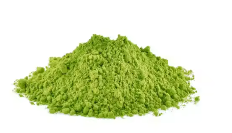 Pile of green matcha powder on a white background